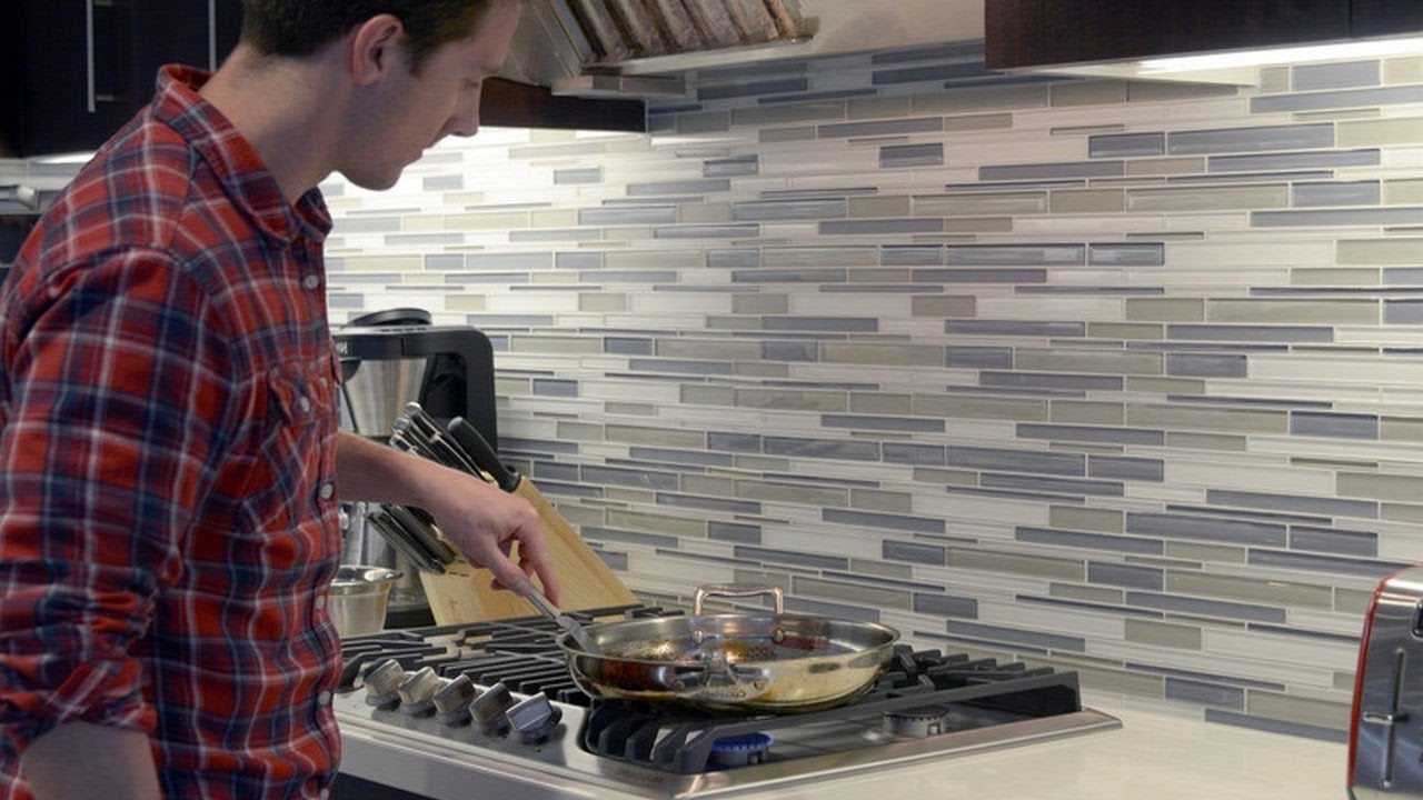 Glenn cooking in a built in gas cooktop.